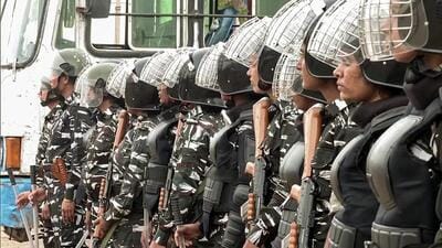 Paramilitary personnel stand guard in Haryana's Nuh as curfew is imposed following clashes between two groups, in Nuh on Thursday. (ANI)