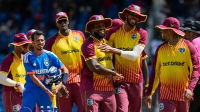 West Indies' Roston Chase, right, and Kyle Mayers embrace after defeating India for 4 runs (AP)