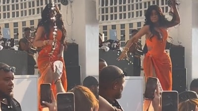Cardi B, in orange dress on stage, during her Las Vegas show. Cardi B, in orange dress on stage, during her Las Vegas show.
