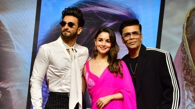 Director Karan Johar poses with stars Ranveer Singh and Alia Bhatt at the success meet of Rocky Aur Rani Kii Prem Kahaani. Karan has shared how the wedding song Kudmayi in the film was shot four days after Alia Bhatt's real wedding with actor Ranbir Kapoor. Karan revealed that the ‘mehendi’ that she sports in the song was the real design that was used for her own wedding. (Varinder Chawla) Director Karan Johar poses with stars Ranveer Singh and Alia Bhatt at the success meet of Rocky Aur Rani Kii Prem Kahaani. Karan has shared how the wedding song Kudmayi in the film was shot four days after Alia Bhatt's real wedding with actor Ranbir Kapoor. Karan revealed that the ‘mehendi’ that she sports in the song was the real design that was used for her own wedding. (Varinder Chawla)