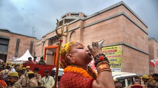 Mahamandaleshwar Hemangi Sakhi of Kinnar Akhara blows a conch after the Allahabad High Court gave the go-ahead for a scientific survey at Gyanvapi Monsque, in Varanasi, Thursday. (PTI)