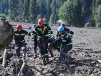 Rescue workers carry the body of a victim of a landslide, near Shovi, about 140 kilometers (85 miles) northwest of the capital Tbilisi, Georgia, Friday. Rescue workers carry the body of a victim of a landslide, near Shovi, about 140 kilometers (85 miles) northwest of the capital Tbilisi, Georgia, Friday.