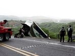 Authorities work to remove a passenger bus that plunged off a highway killing several people, in Tepic, Mexico.