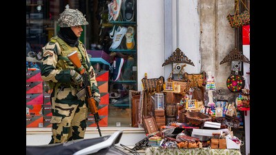 A BSF personnel stands guard on a street, a day before the fourth anniversary of the abrogation of Article 370 of the Constitution, in Srinagar, on Friday. (PTI)
