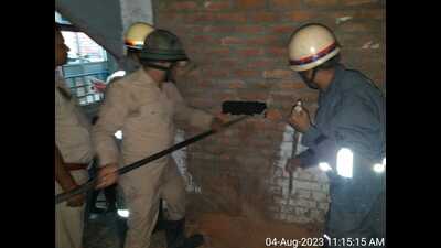 Firefighters working to rescue the worker who fell in an under-construction lift duct (HT Photo)