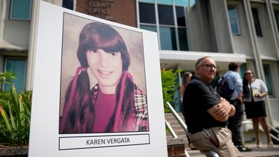 Suffolk County District Attorney Raymond Tierney speaks at a news conference to announce the identity of a victim investigators had called the "Jane Doe No. 7," as Karen Vergata, pictured at left, Friday, Aug. 4, 2023, in Hauppauge, New York. Law enforcement authorities said Friday they have identified a woman whose remains were found as far back as 1996 in different spots along the Long Island coast, some of them near the Gilgo Beach locations of bodies investigators believe were left by a serial killer. (AP) Suffolk County District Attorney Raymond Tierney speaks at a news conference to announce the identity of a victim investigators had called the "Jane Doe No. 7," as Karen Vergata, pictured at left, Friday, Aug. 4, 2023, in Hauppauge, New York. Law enforcement authorities said Friday they have identified a woman whose remains were found as far back as 1996 in different spots along the Long Island coast, some of them near the Gilgo Beach locations of bodies investigators believe were left by a serial killer. (AP)