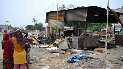 People stand next to a burnt structure in Gurugram, Haryana, on August 4, following sectarian riots. (AFP) People stand next to a burnt structure in Gurugram, Haryana, on August 4, following sectarian riots. (AFP)
