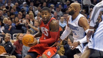 FILE - New Jersey Nets guard Terrence Williams, left, drives past Orlando Magic guard Vince Carter during the first half of an NBA basketball game in Orlando, Fla., on Nov. 5, 2010. A federal judge sentenced a former first-round NBA draft pick to 10 years in prison Thursday, Aug. 3, 2023 saying he used his people skills to entice others to aid his $5 million health care fraud after he “frittered away” substantial earnings from his professional career. (AP Photo/Phelan M. Ebenhack, File) (AP)