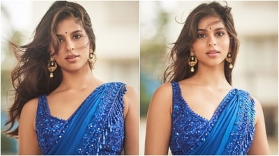 Suhana wore the saree elegantly in traditional style, making neat pleats on the front and the pallu. She matched the six yards with an electric blue-coloured sleeveless blouse featuring a scalloped hem, a plunging neckline, cropped silhouette exposing her toned abs, fitted bust, and heavy cutdana embroidery in similar floral patterns. (Instagram) Suhana wore the saree elegantly in traditional style, making neat pleats on the front and the pallu. She matched the six yards with an electric blue-coloured sleeveless blouse featuring a scalloped hem, a plunging neckline, cropped silhouette exposing her toned abs, fitted bust, and heavy cutdana embroidery in similar floral patterns. (Instagram)