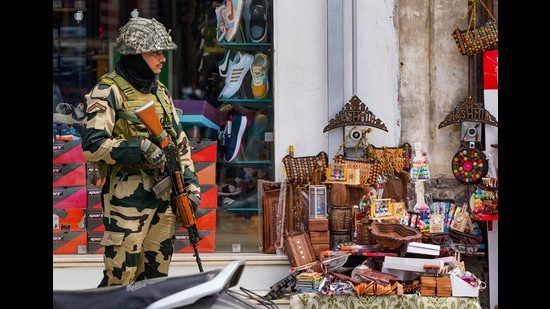 A BSF personnel stands guard on a street, a day before the fourth anniversary of the abrogation of Article 370 of the Constitution, in Srinagar, on Friday. (PTI)