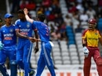 Ishan Kishan (L), Hardik Pandya (2L) and Yuzvendra Chahal (3L) of India celebrate during the first T20I against West Indies