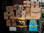 An Amazon delivery worker pulls a delivery cart full of packages during its annual Prime Day promotion in New York City, US. 