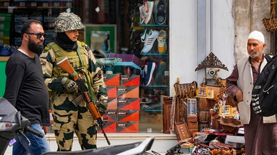 A BSF personnel stands guard on a street, a day before the fourth anniversary of the abrogation of Article 370 of the Constitution, in Srinagar, Friday. (PTI) A BSF personnel stands guard on a street, a day before the fourth anniversary of the abrogation of Article 370 of the Constitution, in Srinagar, Friday. (PTI)