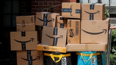 An Amazon delivery worker pulls a delivery cart full of packages during its annual Prime Day promotion in New York City, US. (Reuters)