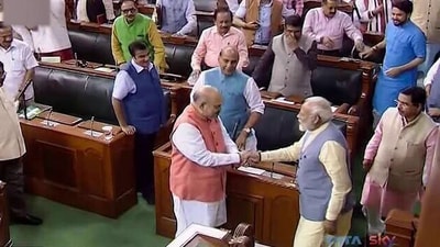Prime Minister Narendra Modi congratulating Home Minister Amit Shah on abrogation of Article 370 in 2019. Prime Minister Narendra Modi congratulating Home Minister Amit Shah on abrogation of Article 370 in 2019.