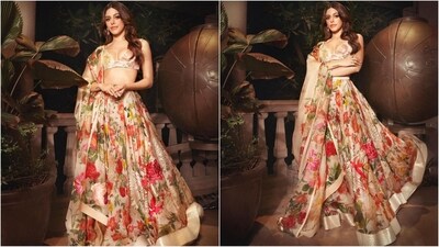 Her outfit features a cream-coloured blouse with a deep v-neckline, puff sleeves and an all-over floral digital print in shades of yellow, red and green. It is paired with a matching ghera lehenga and a net dupatta. (Instagram/@alayaf) Her outfit features a cream-coloured blouse with a deep v-neckline, puff sleeves and an all-over floral digital print in shades of yellow, red and green. It is paired with a matching ghera lehenga and a net dupatta. (Instagram/@alayaf)