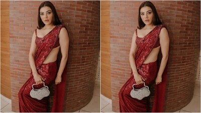 Her exquisite saree comes with a hefty price tag of <span class='webrupee'>₹</span>275,000. As far as accessories go, she kept it minimal, opting for a unique flower-shaped statement bag featuring pearls and silver sequins. (Instagram/@kajalaggarwalofficial) Her exquisite saree comes with a hefty price tag of <span class='webrupee'>₹</span>275,000. As far as accessories go, she kept it minimal, opting for a unique flower-shaped statement bag featuring pearls and silver sequins. (Instagram/@kajalaggarwalofficial)