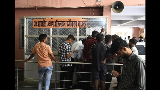 Patients who registered online wait at a counter for OPD slips, (HT)
