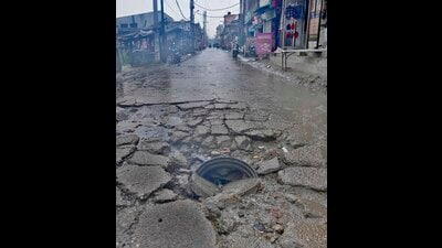 A damaged road and clogged sewage of Durga colony in Ludhiana on Sunday. (Gurpreet Singh/HT) A damaged road and clogged sewage of Durga colony in Ludhiana on Sunday. (Gurpreet Singh/HT)