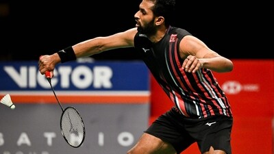 Prannoy H. S. of India hits a return (AFP)