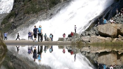 Tourist at the Mendenhall Glacier in the Tongass National Forest are reflected in a pool of water as they make their way to Nuggett Falls. (AP Photo) Tourist at the Mendenhall Glacier in the Tongass National Forest are reflected in a pool of water as they make their way to Nuggett Falls. (AP Photo)