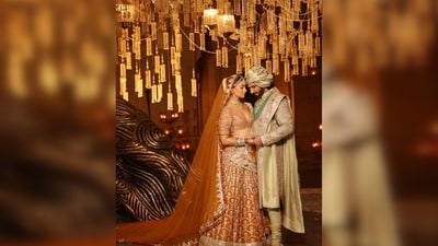 Alia Bhatt was seen wearing an orange embellished lehenga paired with a floor-sweeping veil. She matched her lehenga with a plunging neckline blouse featuring an open back. (Instagram/@manishmalhotra05) Alia Bhatt was seen wearing an orange embellished lehenga paired with a floor-sweeping veil. She matched her lehenga with a plunging neckline blouse featuring an open back. (Instagram/@manishmalhotra05)