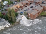 A drone view shows a house collapsing into a river due to glacial floods in Juneau, Alaska, U.S. August 5, 2023, in this screengrab obtained from a video on social media.