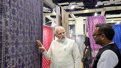 Prime Minister Narendra Modi visited an exhibition organised on the occasion of National Handloom Day. (PTI Photo) Prime Minister Narendra Modi visited an exhibition organised on the occasion of National Handloom Day. (PTI Photo)