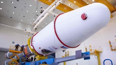 Technicians finishing to assemble a Soyuz 2.1b rocket carrying the Luna-25 lander ahead of its launch scheduled for August 11, 2023, at the Vostochny cosmodrome. (AFP)