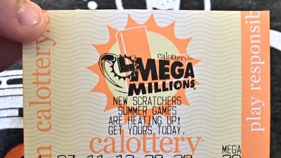 A Mega Millions lottery ticket is displayed in Los Angeles, California, (AFP)