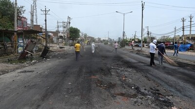 Workers remove the debris and stone from the road near the bus stand in Gurugram after communal violence in Nuh. (HT File) Workers remove the debris and stone from the road near the bus stand in Gurugram after communal violence in Nuh. (HT File)