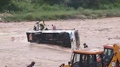 Screengrab of the video showing nearby people attempting to rescue passengers struck in the overturned bus in Nainital, Sunday. Screengrab of the video showing nearby people attempting to rescue passengers struck in the overturned bus in Nainital, Sunday.