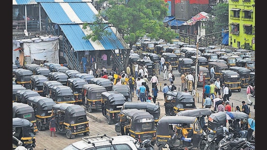 At the exit of Bandra East station, auto rickshaws have blocked the road and footpath. Drivers stand at the end of foot over bridge, trying to coax passengers into traveling in their autos, thereby blocking the easy movement of people. (VIJAY BATE/HT PHOTO)