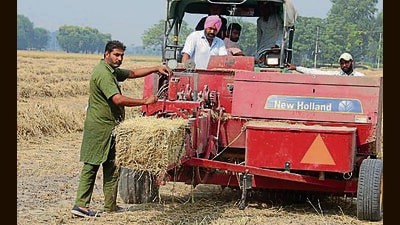 A farmer with a paddy straw management machine at Mehma Sawai village in Bathinda (HT FILE) A farmer with a paddy straw management machine at Mehma Sawai village in Bathinda (HT FILE)