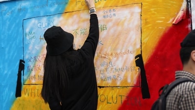 London Brick Lane: Political graffiti is written on a white-washed wall in the Brick Lane area of east London. (AFP) London Brick Lane: Political graffiti is written on a white-washed wall in the Brick Lane area of east London. (AFP)