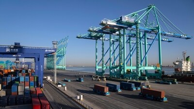A crane lifts a shipping container at an automated port in Tianjin, China. (AP)