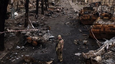 Russia-Ukraine War: A Ukrainian serviceman stands amid destroyed Russian tanks in Bucha, on the outskirts of Kyiv, Ukraine. (AP) Russia-Ukraine War: A Ukrainian serviceman stands amid destroyed Russian tanks in Bucha, on the outskirts of Kyiv, Ukraine. (AP)