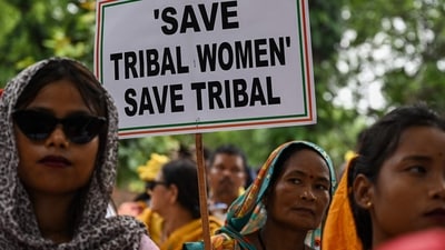 Members of tribal community hold placards and gestures during protest over violence against women and for peace in the ongoing ethnic violence in Manipur, in New Delhi on August 3. (AFP) Members of tribal community hold placards and gestures during protest over violence against women and for peace in the ongoing ethnic violence in Manipur, in New Delhi on August 3. (AFP)