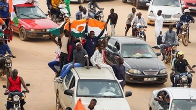 Anti-sanctions protestors hold the Niger flag as they arrive to gather in support of the putschist soldiers in the capital Niamey, Niger August 3, 2023. REUTERS/Balima Boureima (REUTERS)