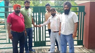 The Motivator Workers Union locking the Punjab water supply and sanitation department’s office in Phase-2, Mohali, on Tuesday. (HT Photo)
