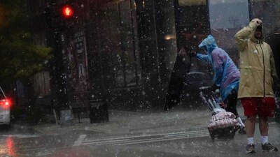 An umbrella is blown inside out as a person crosses the street during a storm in Washington, DC, on August 7, 2023. (AFP) An umbrella is blown inside out as a person crosses the street during a storm in Washington, DC, on August 7, 2023. (AFP)