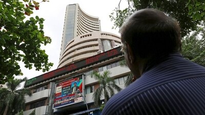 Sensex, Nifty today: A man looks at a screen across a road displaying the Sensex on the facade of the Bombay Stock Exchange (BSE) building in Mumbai. (REUTERS)