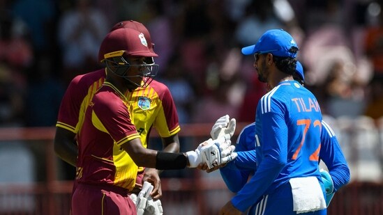 Tilak Varma (R) of India congratulates Akeal Hosein (L) of the West Indies for winning the 2nd T20I match (AFP)