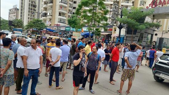 Residents of the Gaur City 2 society staged a protest and created a roadblock outside the complex on Sunday. (HT Photo)