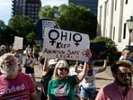 FILE PHOTO: An abortion rights protester holds a sign to keep abortion safe in Ohio at a rally in Columbus, Ohio, after the United States Supreme Court ruled in the Dobbs v Women's Health Organization abortion case, overturning the landmark Roe v Wade abortion decision, June 24, 2022.  REUTERS/Megan Jelinger/File Photo