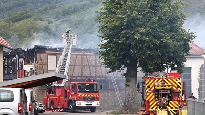 Firefighters work to extinguish a fire which erupted at a home for disabled people in Wintzenheim near Colmar, eastern France. (AFP)