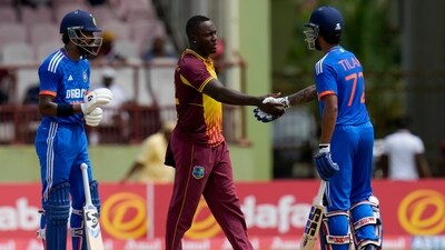 India's Tilak Varma (Right) shakes hands with Rovman Powell as Hardik Pandya looks on after India's 7-wicket win. (AP)