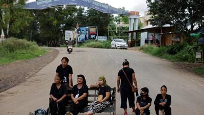 Kuki women sit on a bench as they guard a checkpoint on a road in Churachandpur district in the northeastern state of Manipur. (REUTERS File) Kuki women sit on a bench as they guard a checkpoint on a road in Churachandpur district in the northeastern state of Manipur. (REUTERS File)