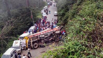 Locals gather around mangled remains of vehicles after an apple-laden truck reportedly went out of control, hit four vehicles, turned turtle, and crushed two people, in Chhaila area of Shimla district, Wednesday. (PTI) Locals gather around mangled remains of vehicles after an apple-laden truck reportedly went out of control, hit four vehicles, turned turtle, and crushed two people, in Chhaila area of Shimla district, Wednesday. (PTI)