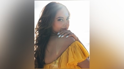 Sonakshi's dress comes in a dual-tone shade - bright yellow with a broad fuchsia-pink border. It features an off-the-shoulder plunging neckline highlighting her decolletage. (Instagram) Sonakshi's dress comes in a dual-tone shade - bright yellow with a broad fuchsia-pink border. It features an off-the-shoulder plunging neckline highlighting her decolletage. (Instagram)
